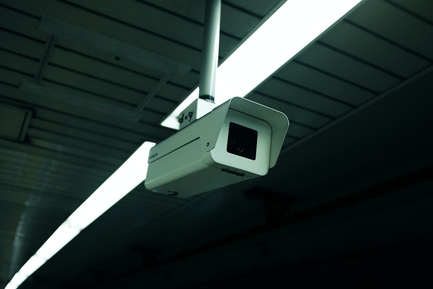 Wall-mounted CCTV camera covering a storefront