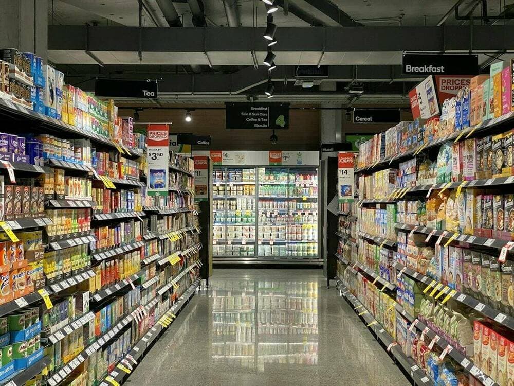 Interior of a convenience store with shelves and a checkout counter